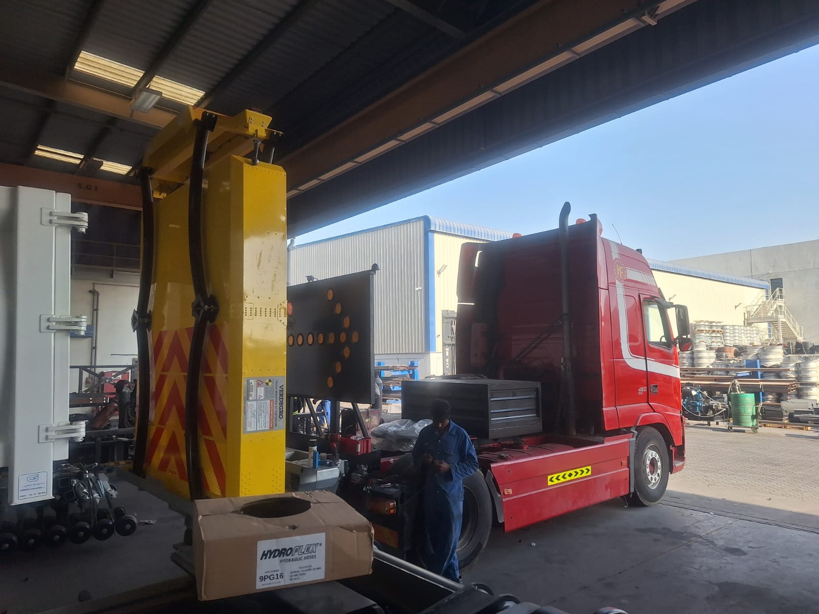 Road Works technicians inspecting and servicing a truck mounted attenuator unit before deployment